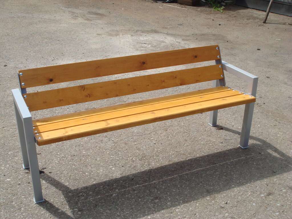 Wooden bench with metal frame on asphalt