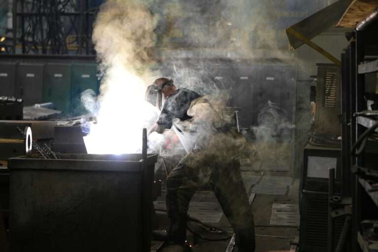 Estdoor metalworks employee working in fabrication area