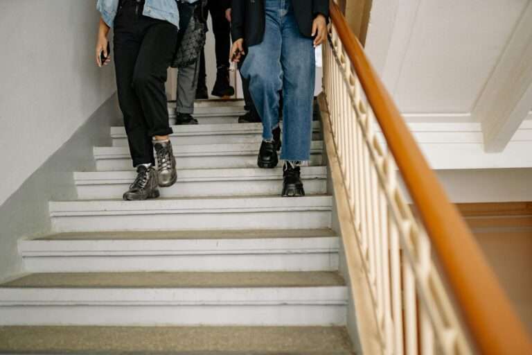 Indoor metal stairs in a modern school hallway
